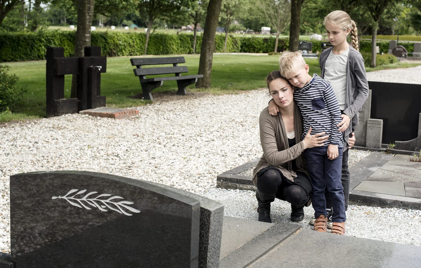 Wrongful death. Family grieving at grave.