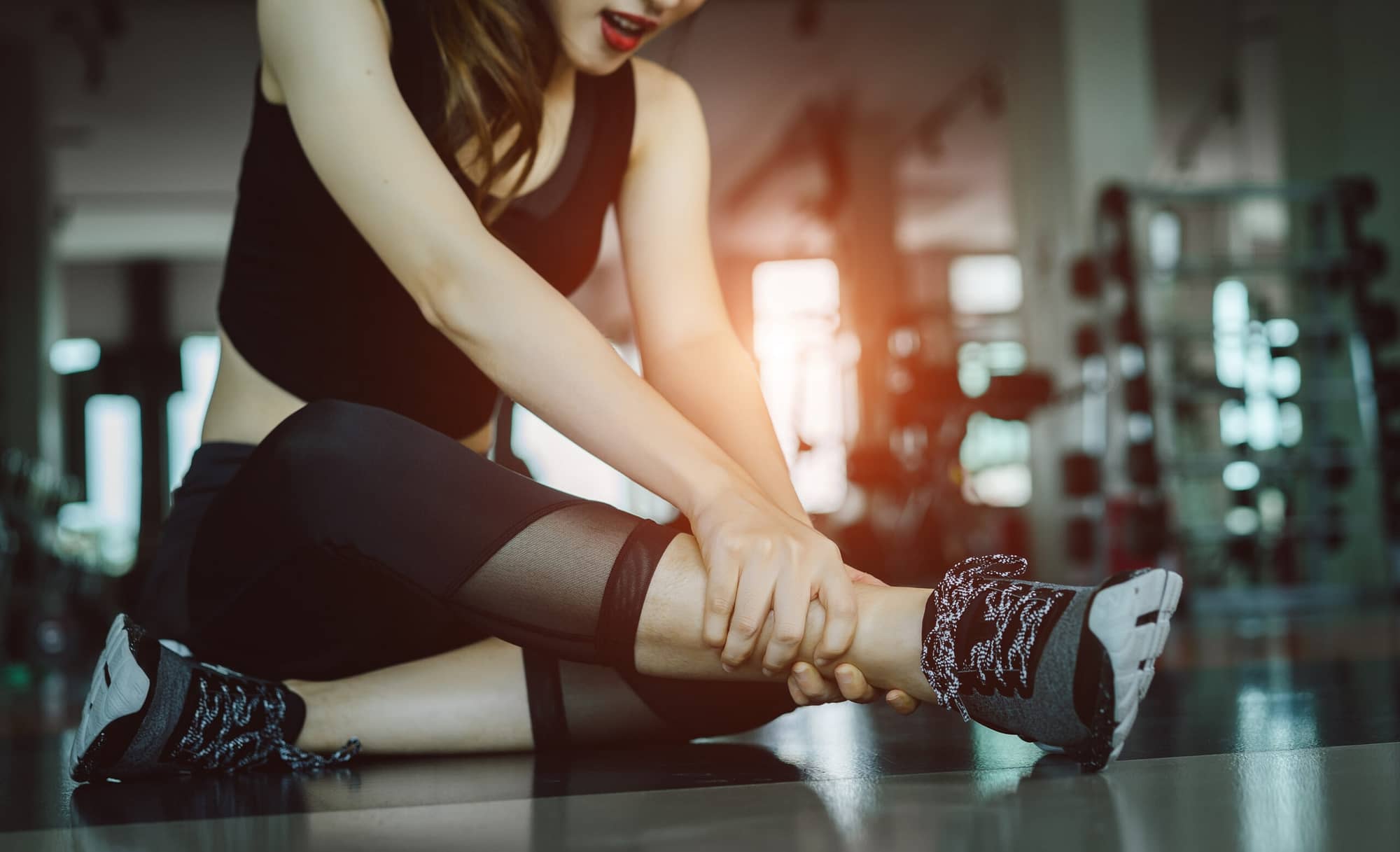 Woman doing sport exercise injury leg accident at gym fitness. Brownsville Personal Injury Lawyer