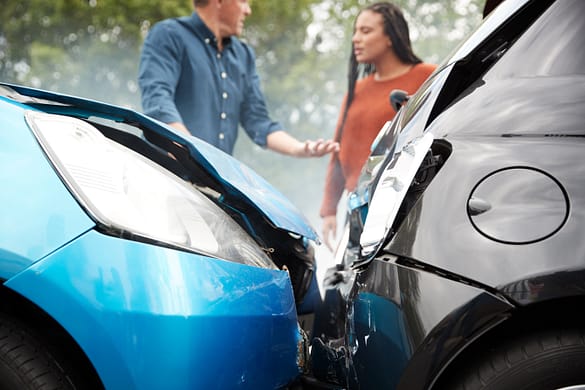 Rear end car accident with a man and woman talking - Can a Car Accident Cause a Miscarriage?