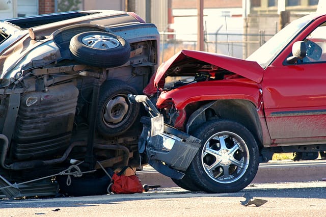 Car wreck involving two cars with a car rolled over - Flower Mound Accident Lawyers
