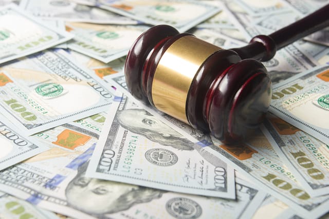 Gavel sitting on top of $100 bills - Personal Injury Lawyer Experienced in Handling Injury Claims During Bankruptcy
