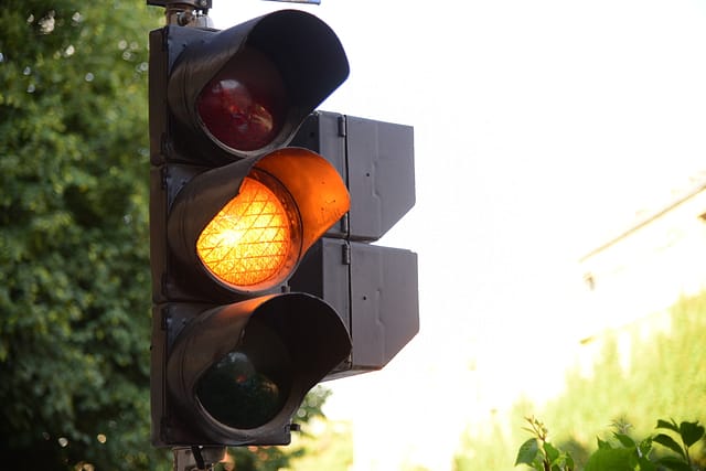 Yellow light of traffic lights in summer city - Is it Legal to Run a Yellow Light in Texas?