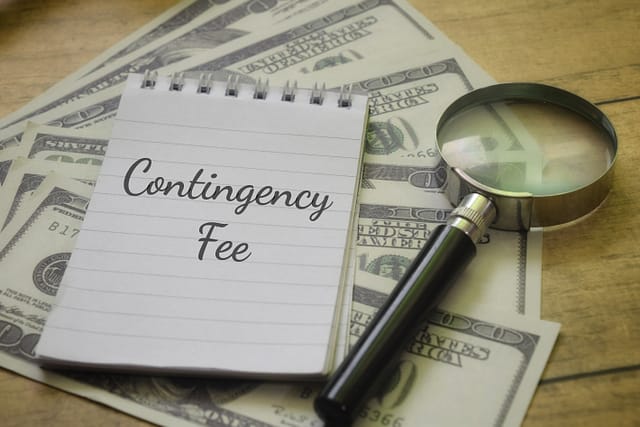 Contingency Fee wording with magnifying glass and money.