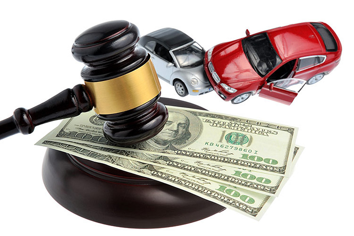 Two toy cars that look like they've been in a wreck next to a gavel on top of 3 hundred dollar bills. Getting a Lawyer for a Car Accident