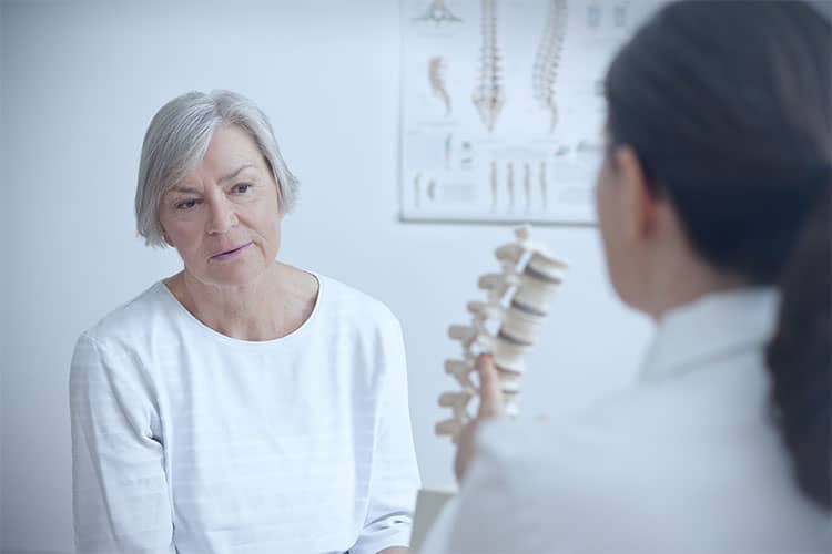 Doctor and patient discussing quality of life after spine surgery
