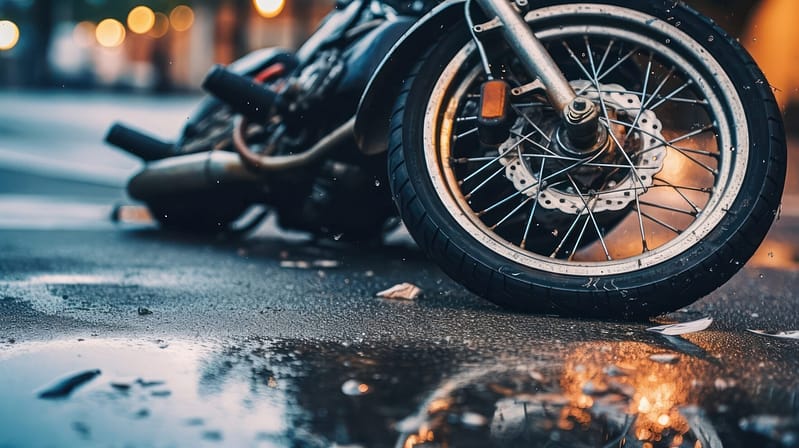 Motorcycle Wreck in Busy Intersection with close-up of a motorcycle accident on the city street and a broken motorcycle on the roadway. New Braunfels motorcycle accident lawyers