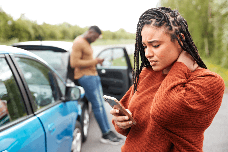Woman holding her neck after a car wreck. Ways to help strengthen your personal injury case.