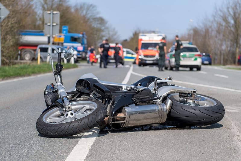 Motorcycle Traffic Accident: Broken Bike on the Street after Crash. Conroe Motorcycle Accident Lawyers