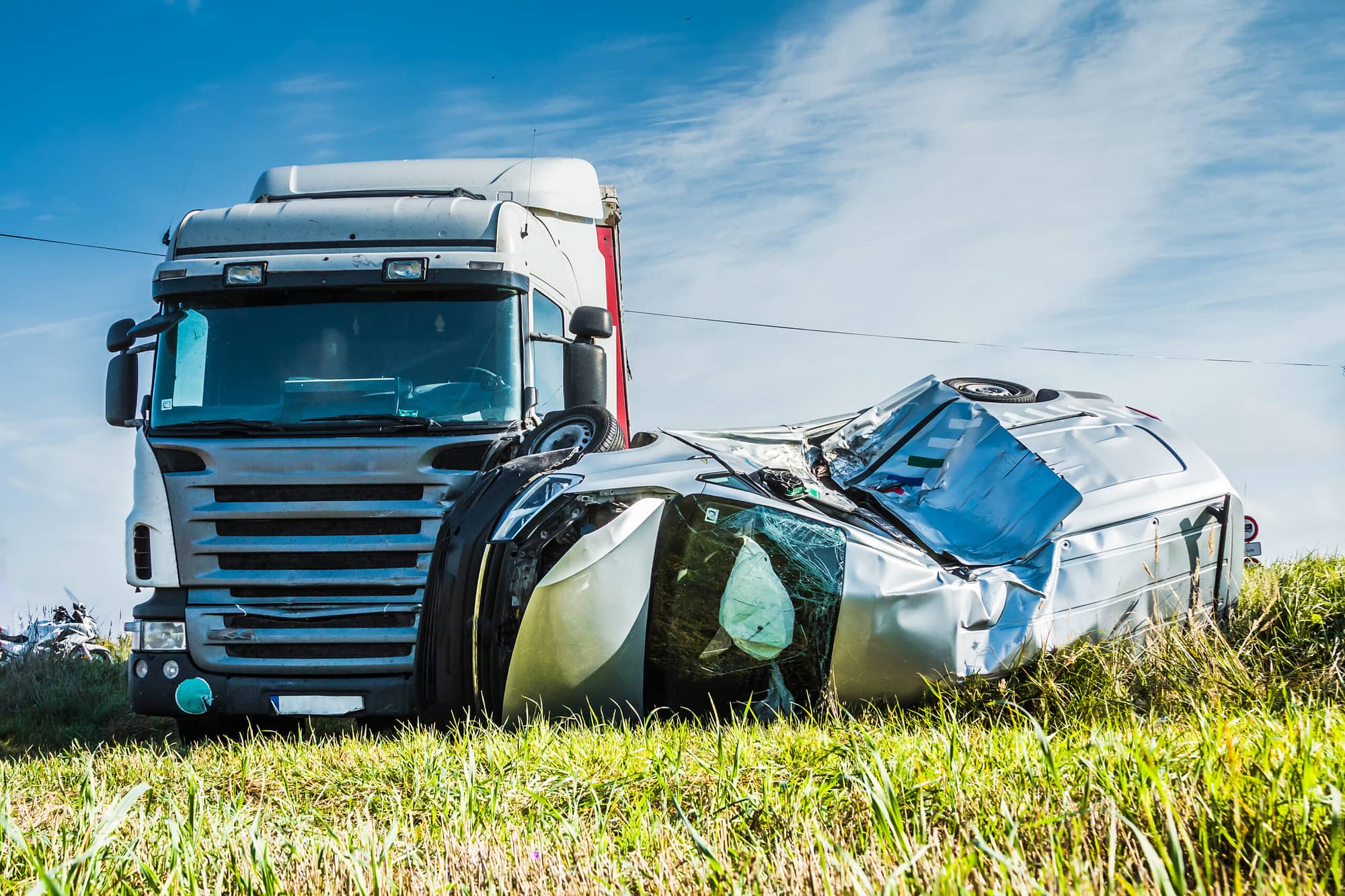 Car accident on a road in September, car after a collision with a heavy truck, transportation background. Compensation